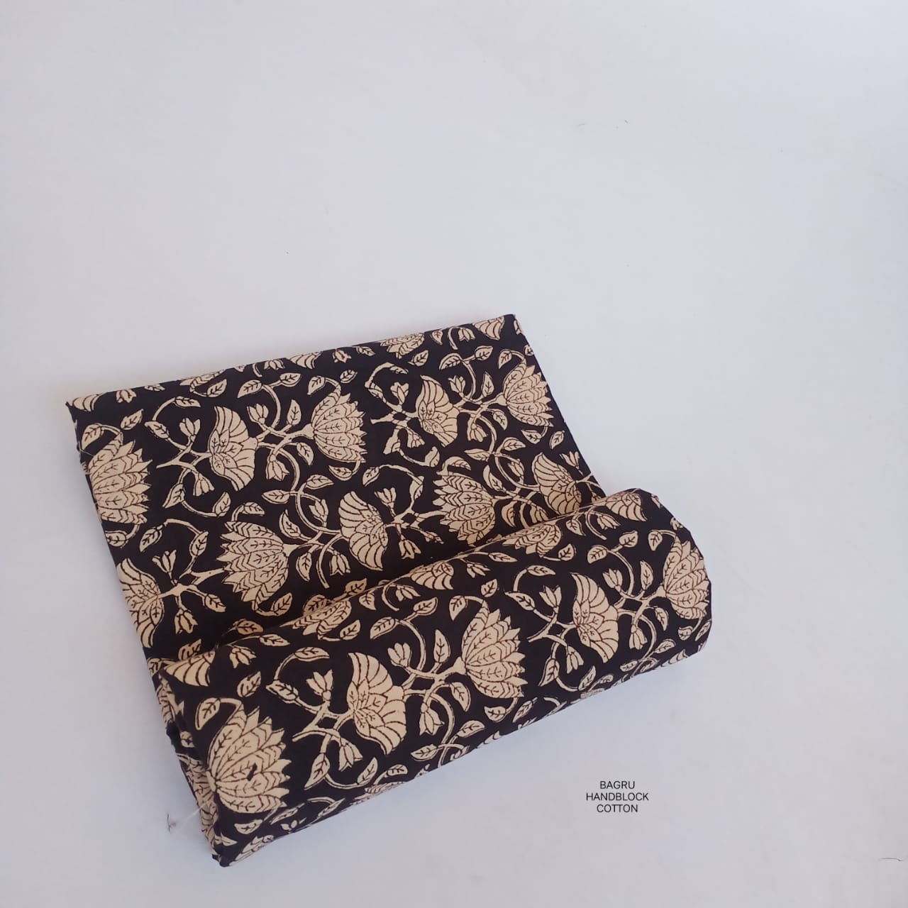 Black floral jaal Bagru handblock printed cotton fabric, artisan-made textile ideal for ethnic and contemporary wholesale buyers.