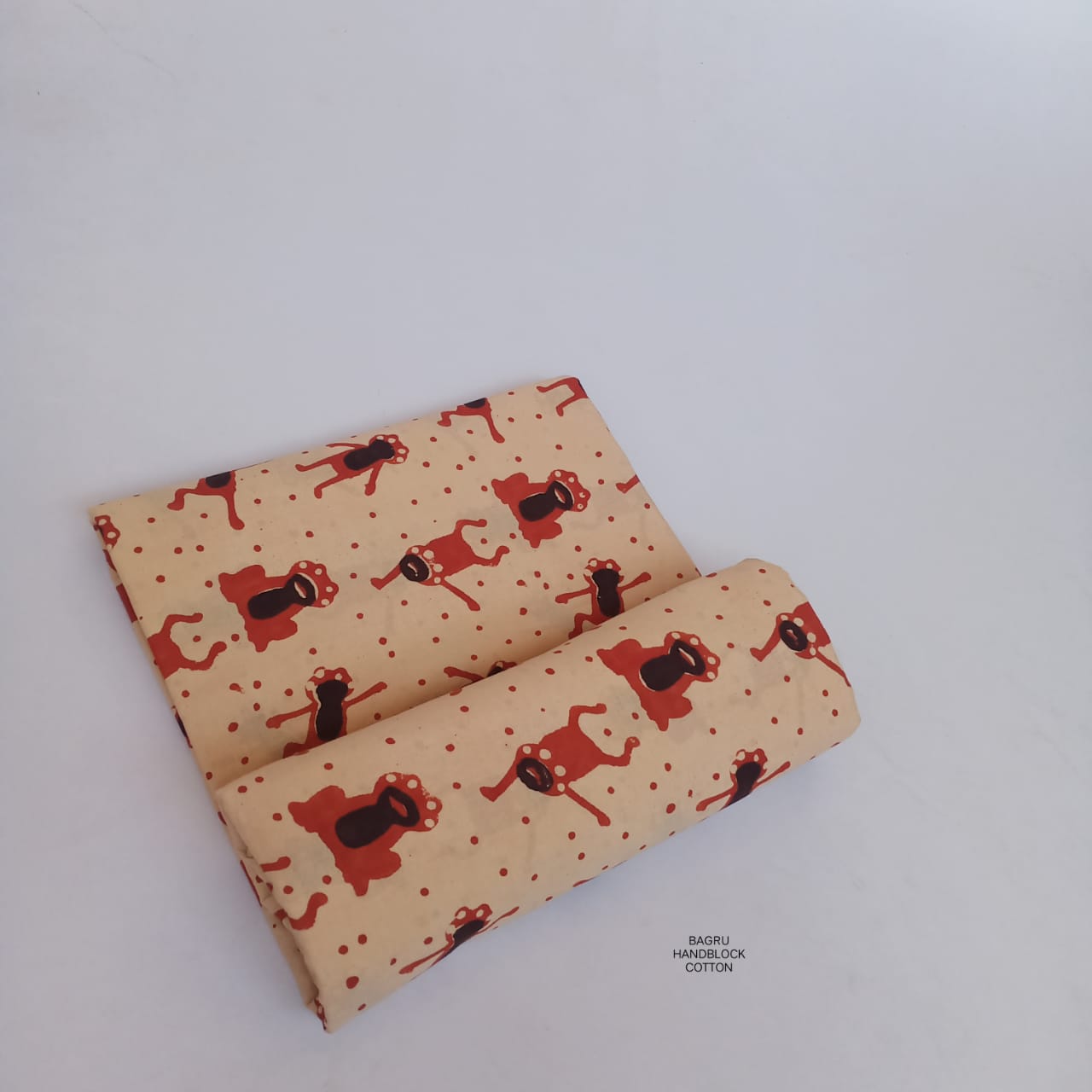 Cream and red Bagru handblock printed pure cotton fabric featuring playful frog prints, naturally dyed and artisan-crafted.