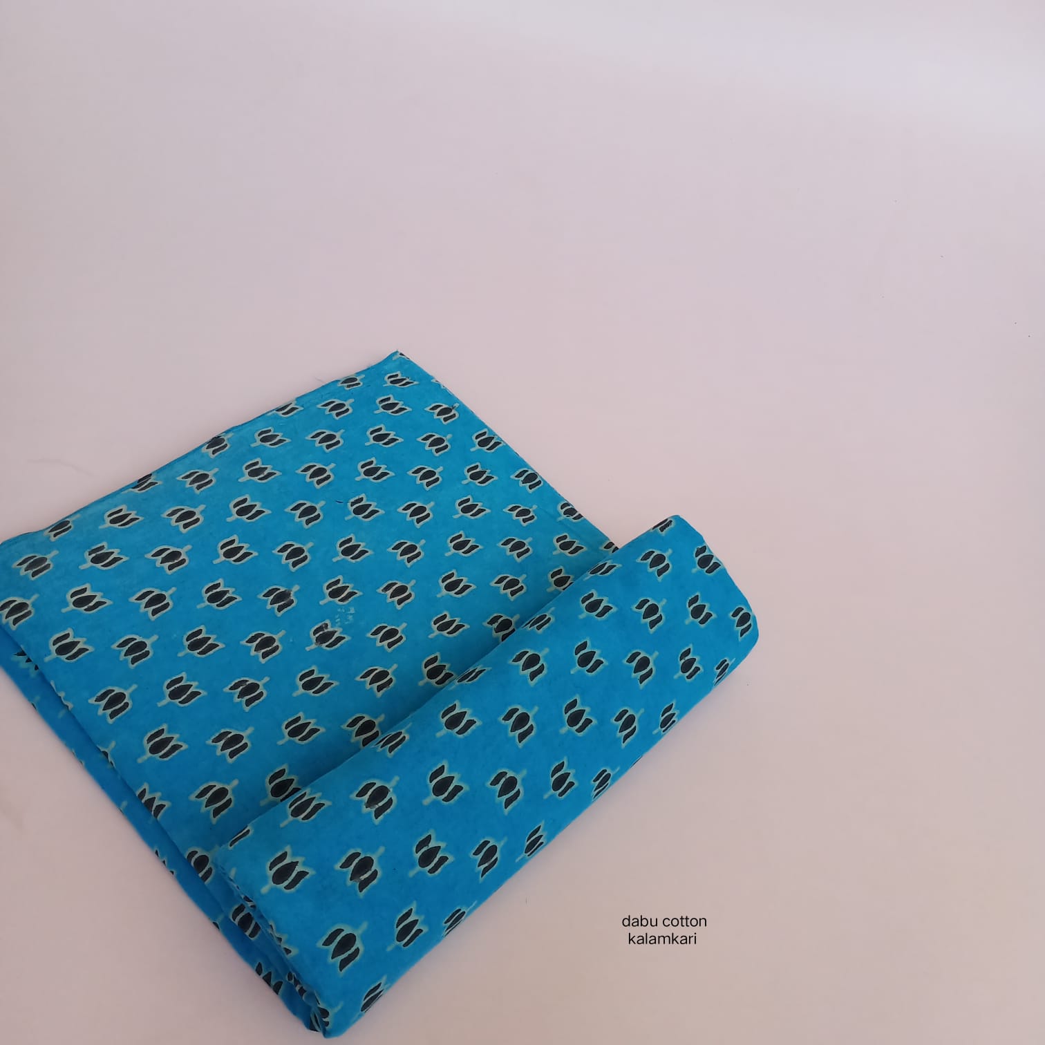 Blue lotus Dabu handblock printed cotton fabric, traditional Rajasthan craft available wholesale.