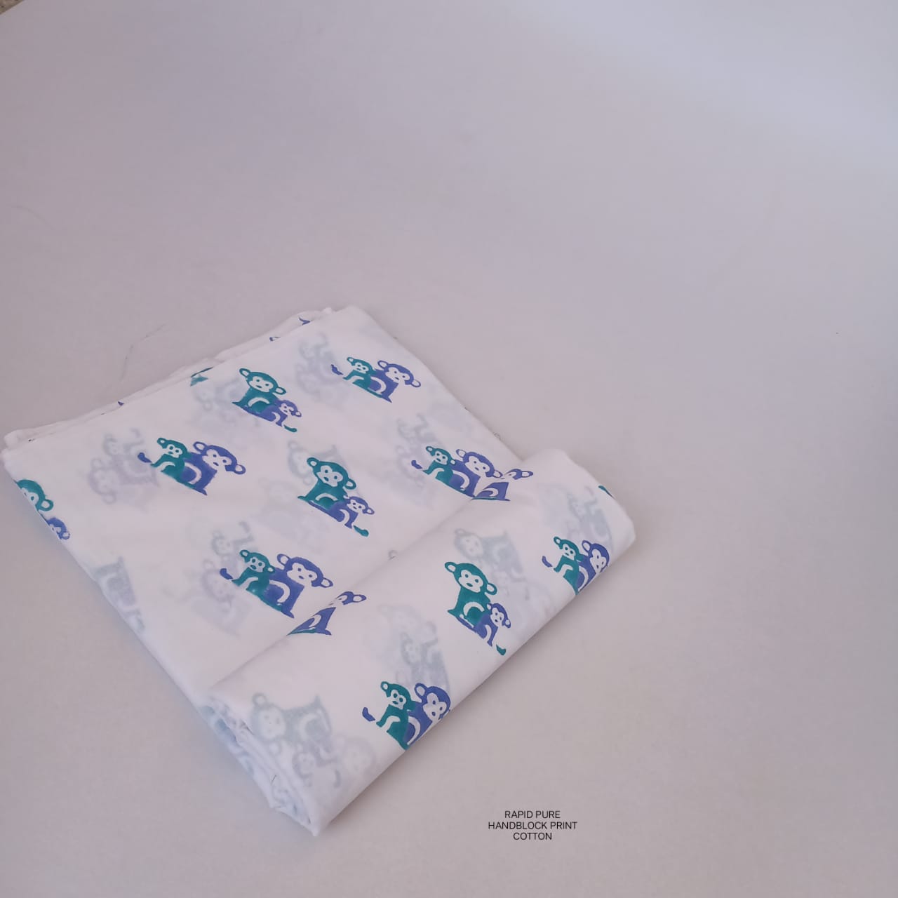 Jaipur Sanganeri Handblock Cotton Fabric in white and blue with monkey butti print, artisan-made and ideal for boutiques, designers, and retailers.