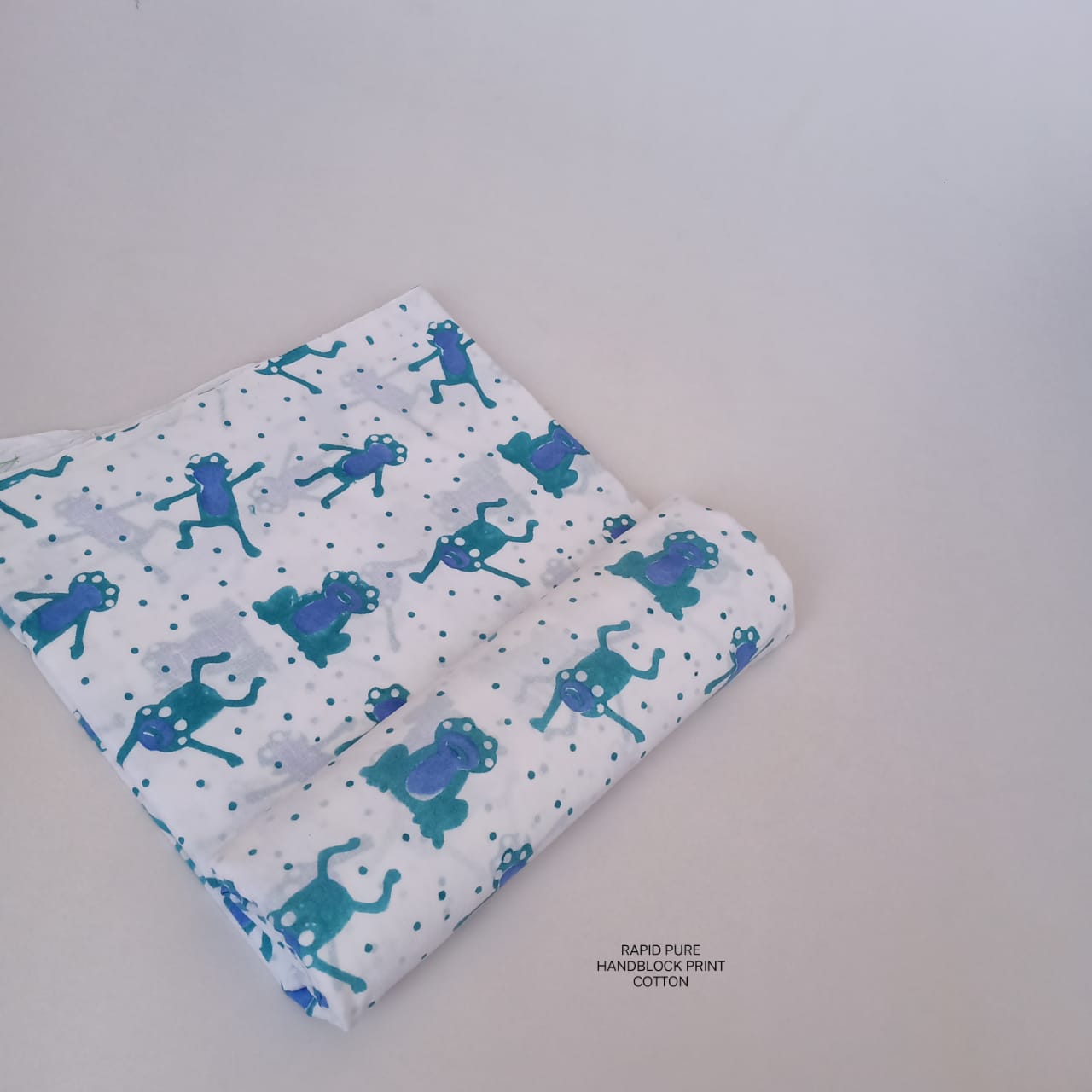 Artisan-crafted Jaipur Sanganeri Handblock Cotton Fabric in white and blue with monkey print, perfect for B2B wholesale orders.