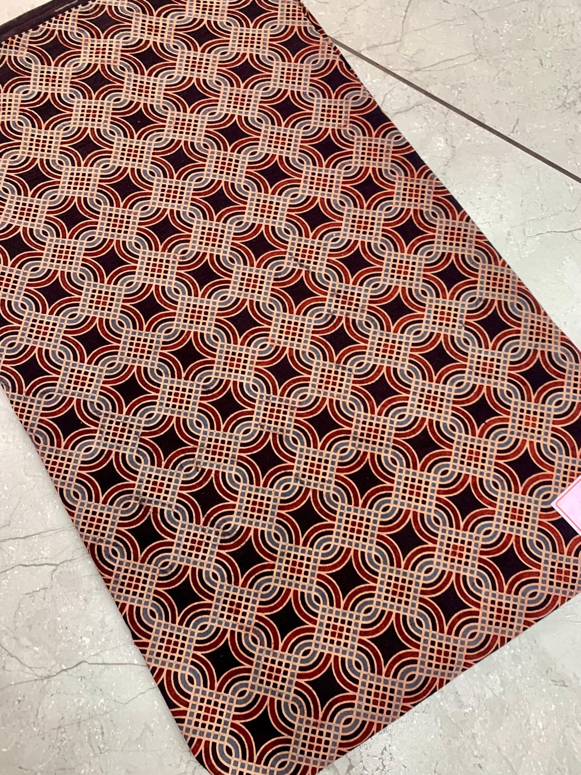 Black Ajrakh handblock printed pure cotton wholesale fabric with bold artisan motifs and traditional dye tones.