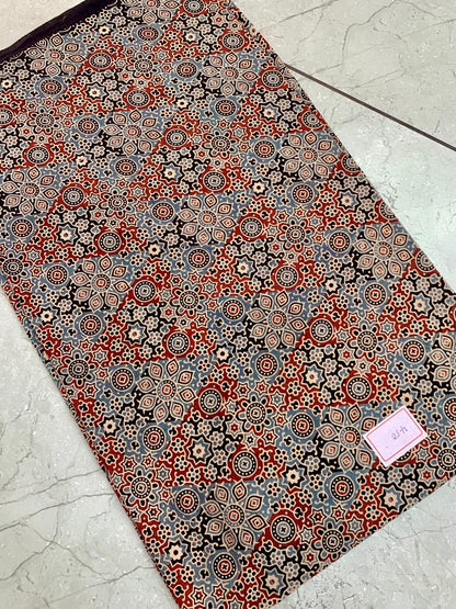 Black and maroon Ajrakh pure cotton wholesale fabric printed with heritage block patterns in deep natural dyes.