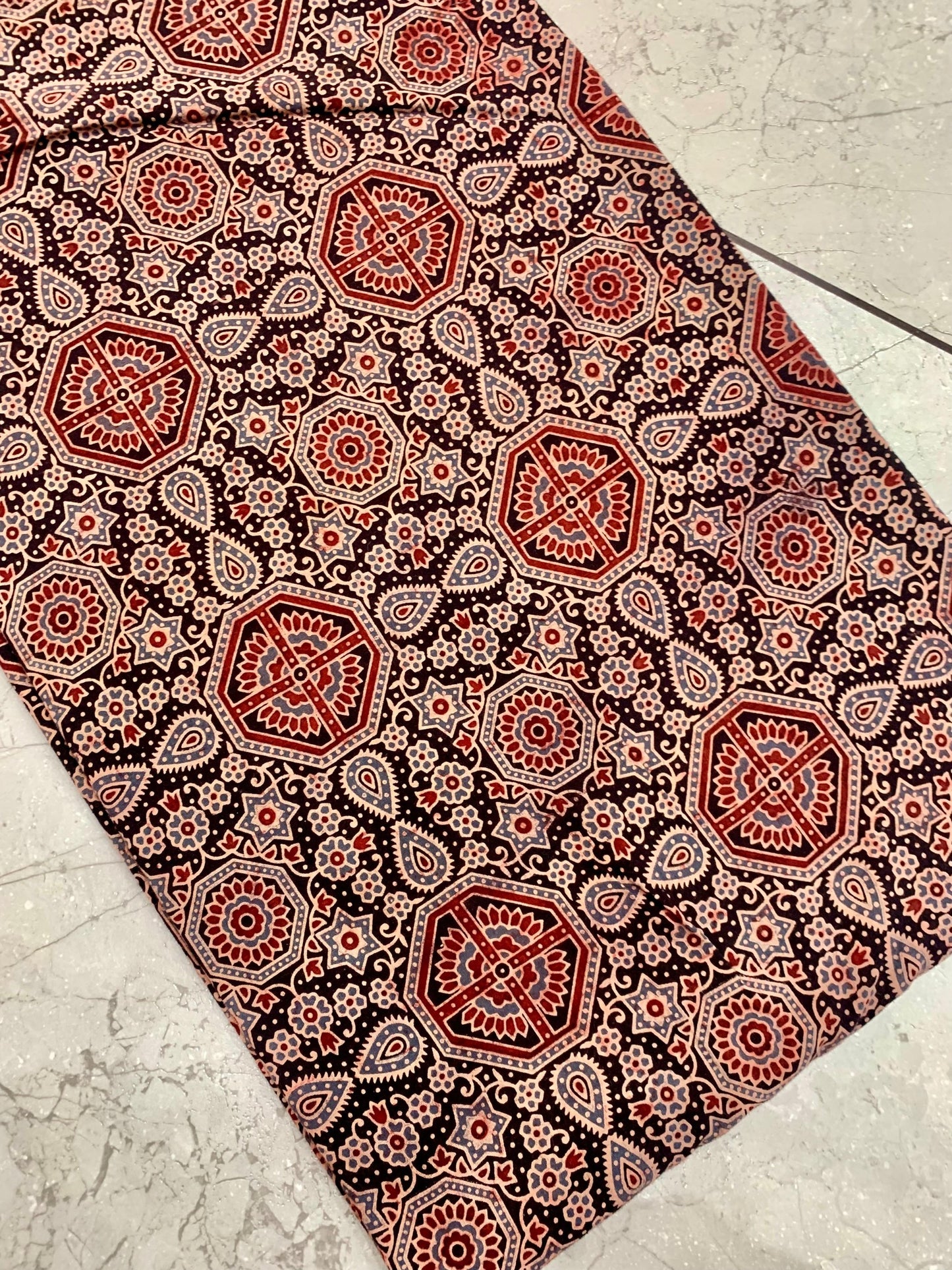 Black-red Ajrakh pure cotton wholesale fabric showcasing classic block-printed patterns for boutique collections.