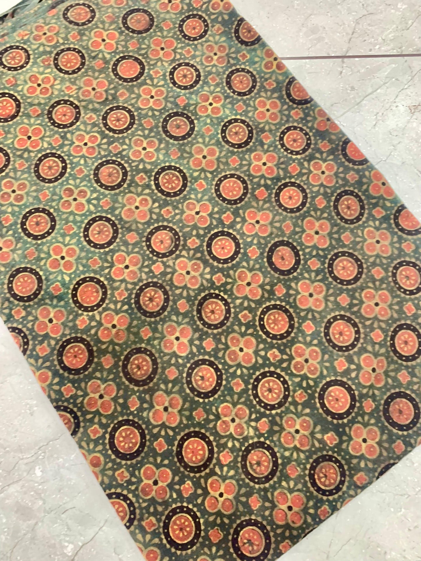 Green Ajrakh floral handblock printed pure cotton wholesale fabric in natural earthy tones by Fabtexs.