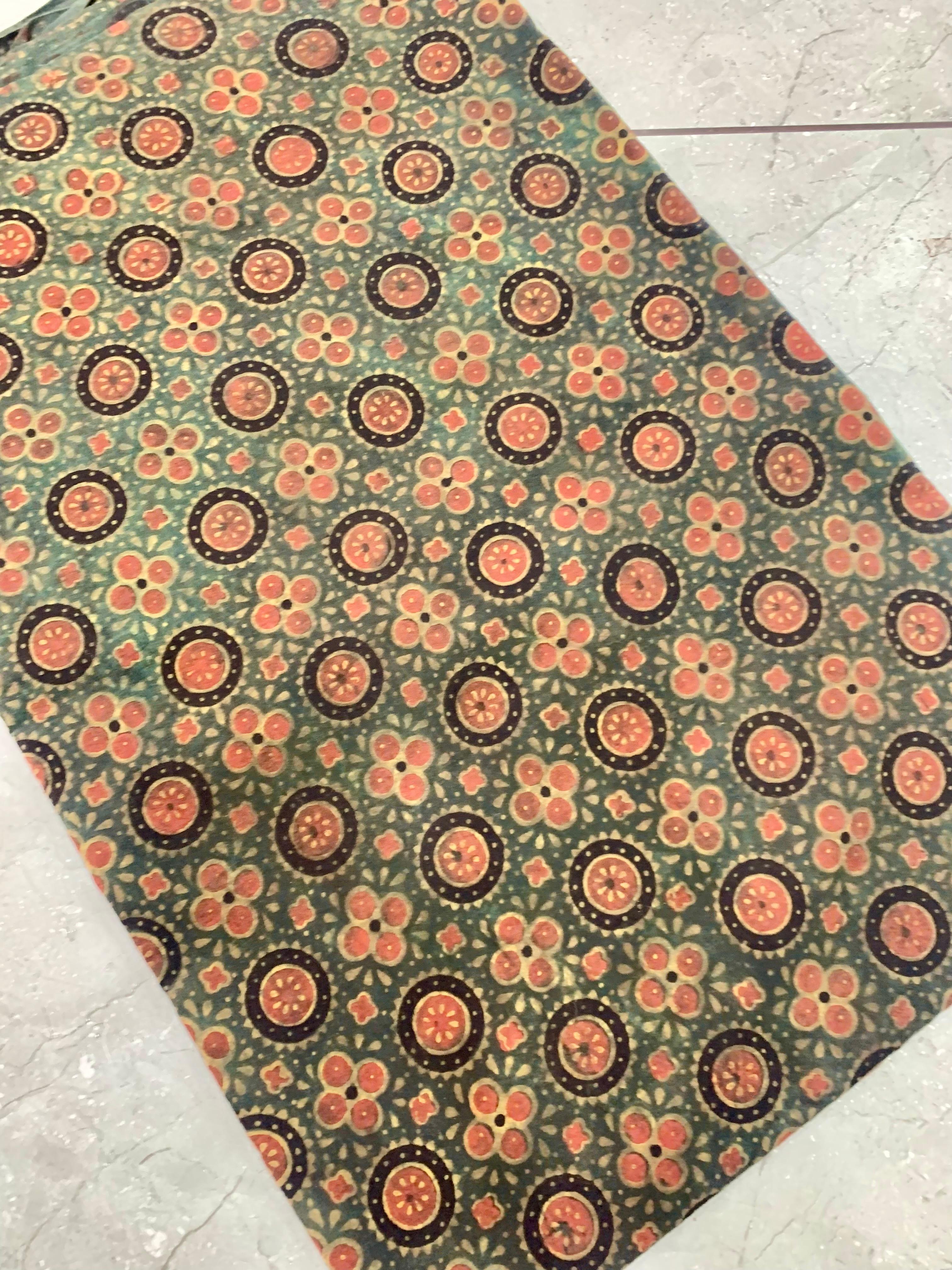 Green Ajrakh floral handblock printed pure cotton wholesale fabric in natural earthy tones by Fabtexs.