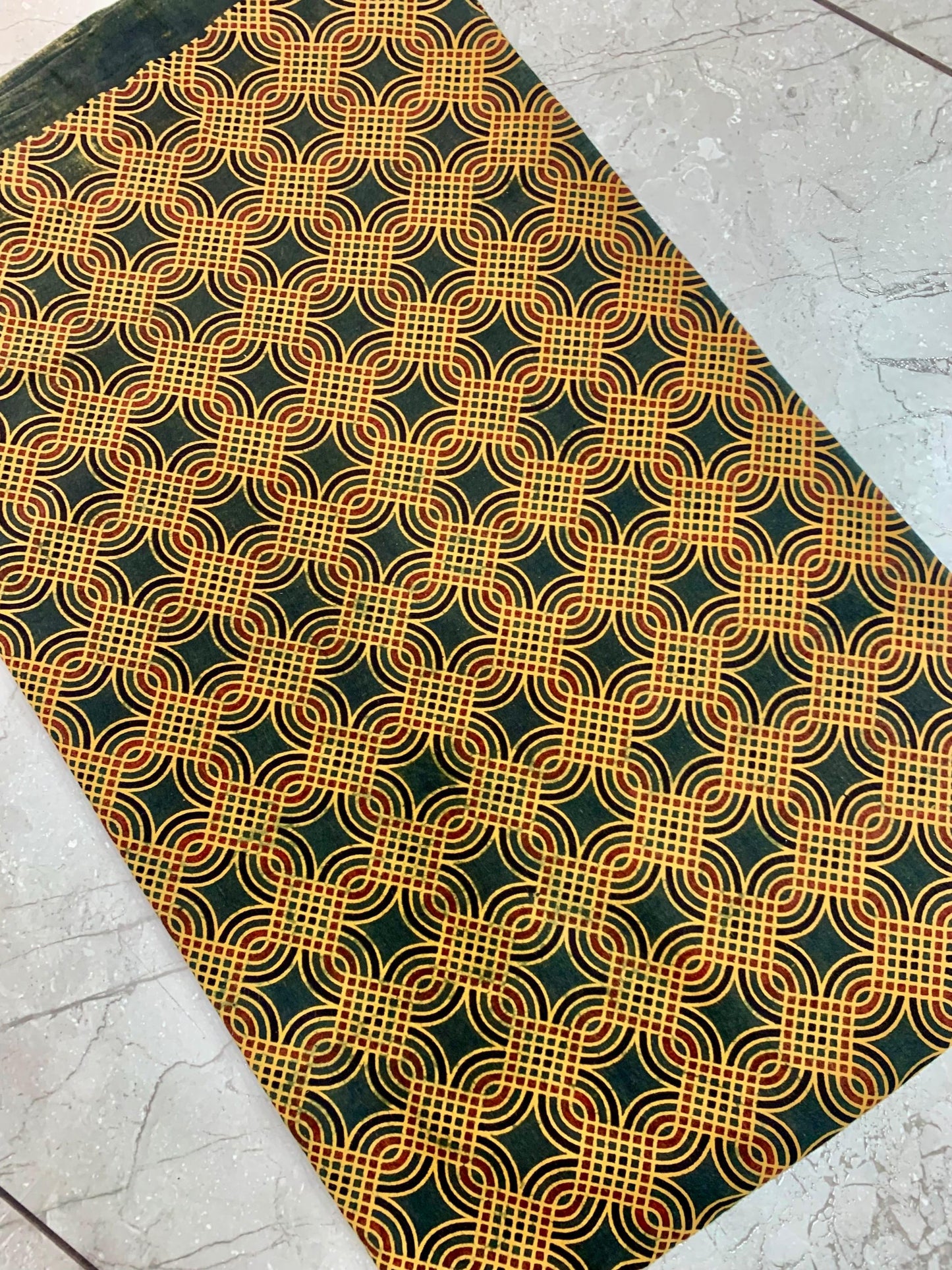 Green geometric Ajrakh print pure cotton fabric wholesale, artisan-made with earthy natural dye patterns.