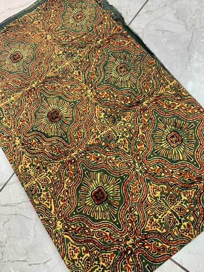 Green Jaal Ajrakh pure cotton wholesale fabric showcasing dense block-printed lattice designs in natural dyes.