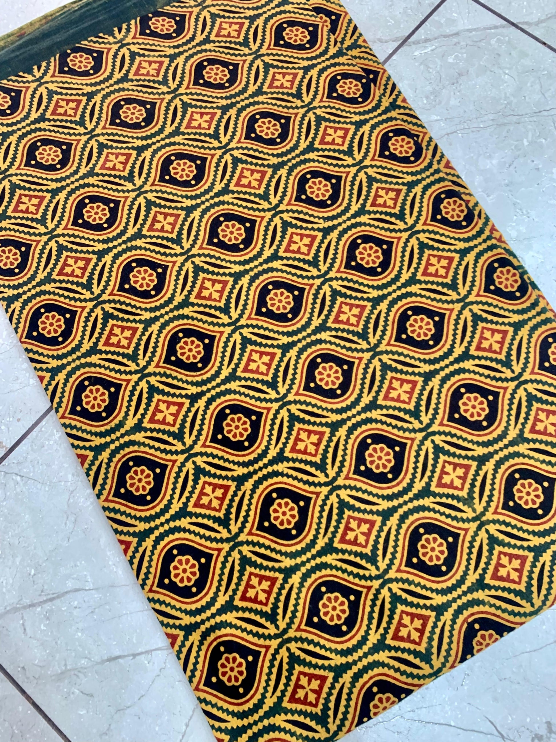 Green motif Ajrakh pure cotton wholesale fabric showcasing handprinted cultural patterns in natural dyes.