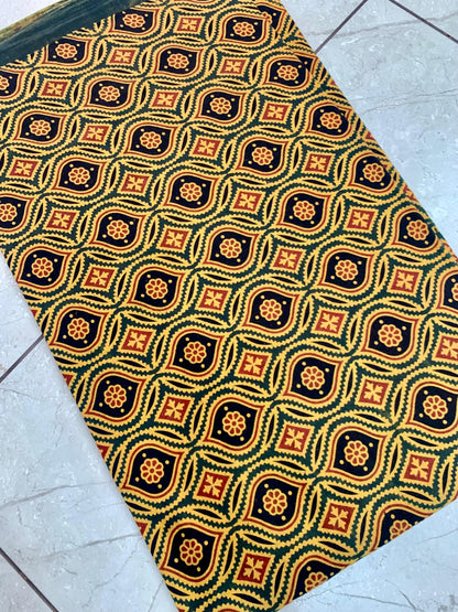 Green motif Ajrakh pure cotton wholesale fabric showcasing handprinted cultural patterns in natural dyes.