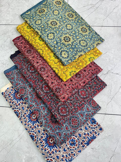 Cream-based multi-color Ajrakh pure cotton handblock printed wholesale fabric, artisan-made by Fabtexs.