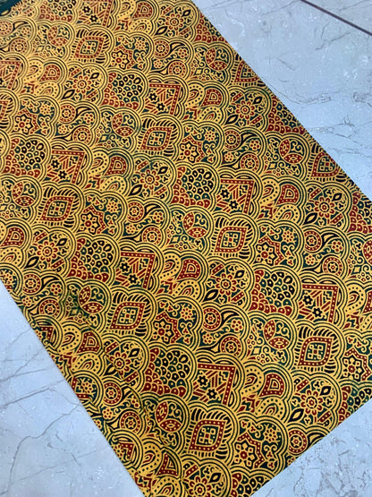 Mustard Ajrakh pure cotton fabric wholesale dyed using natural colors and printed with ethnic artisan motifs.
