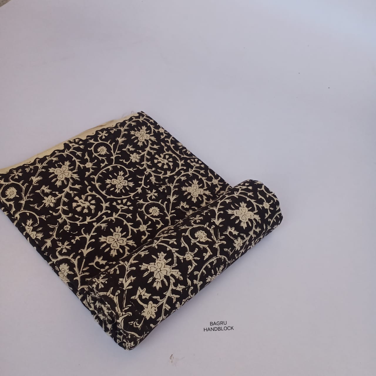 Black floral Bagru handblock printed cotton fabric, handcrafted with precision using natural dyes and traditional motifs.