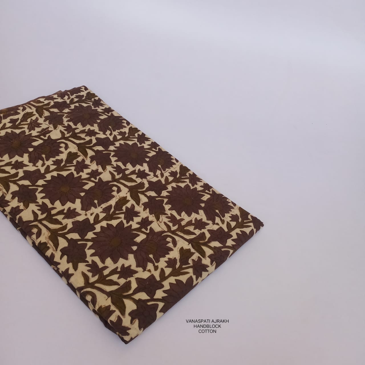 Cream-brown floral jaal Vanaspati Bagru handblock printed pure cotton fabric, artisan-designed and slow-made for Fabtexs buyers.