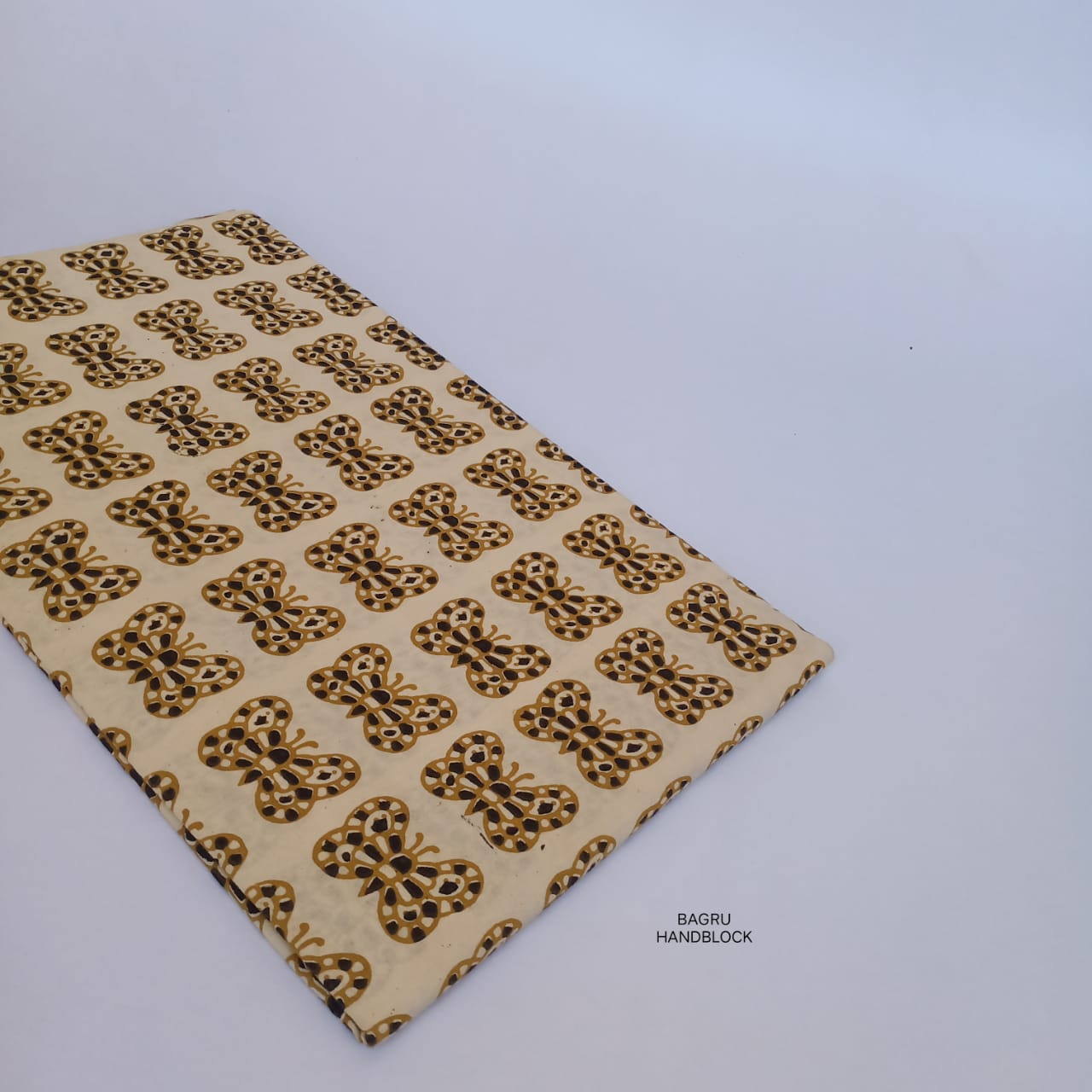 Cream-toned Bagru fabric with butterfly motifs, pure cotton base, printed using age-old handblock techniques.