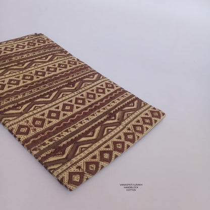 Geometrical Vanaspati pattern Bagru handblock printed pure cotton fabric in cream, naturally dyed and crafted for Fabtexs wholesale.