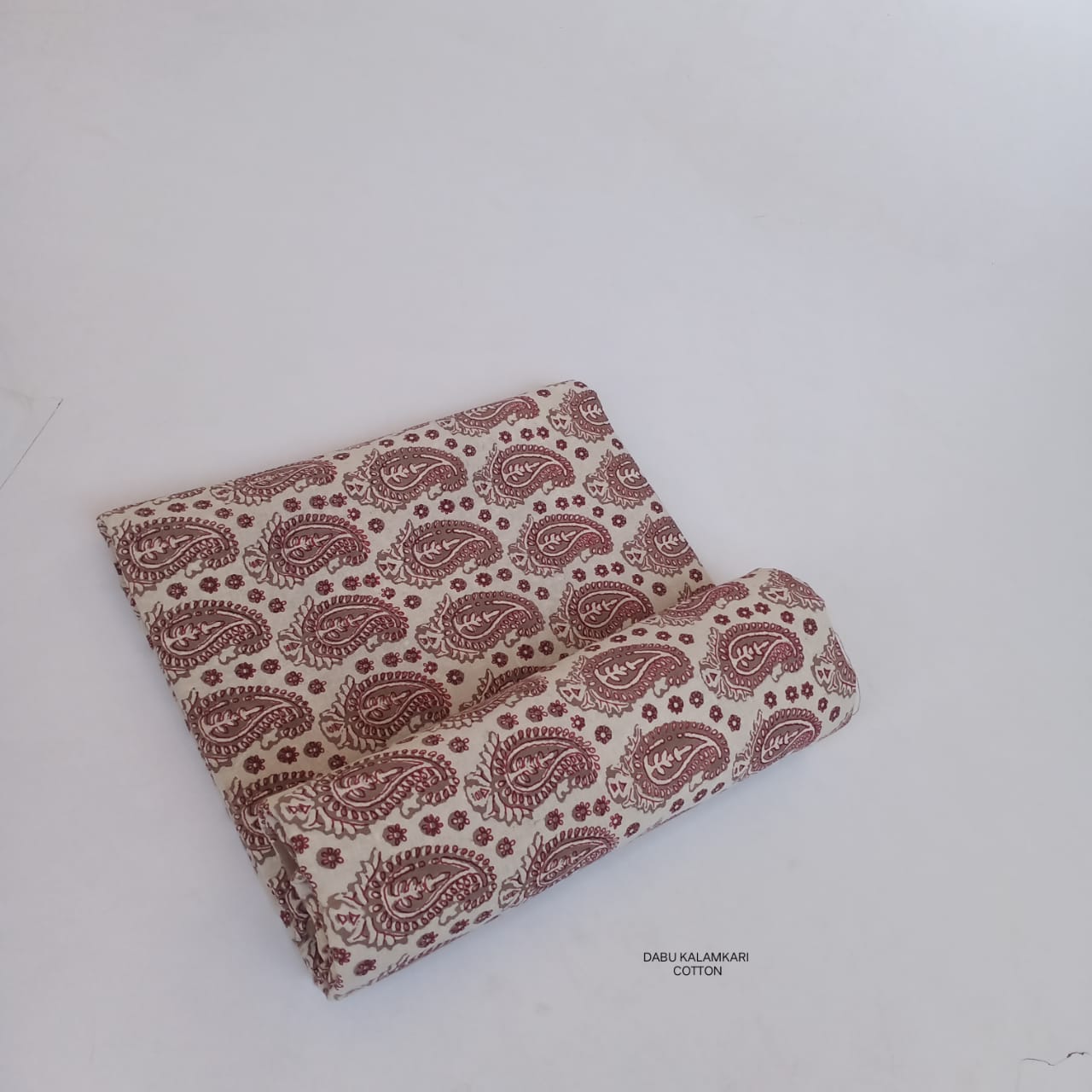 Cream Bagru handblock printed pure cotton fabric with paisley motifs, artisan-made using natural dyes for Fabtexs wholesale buyers.