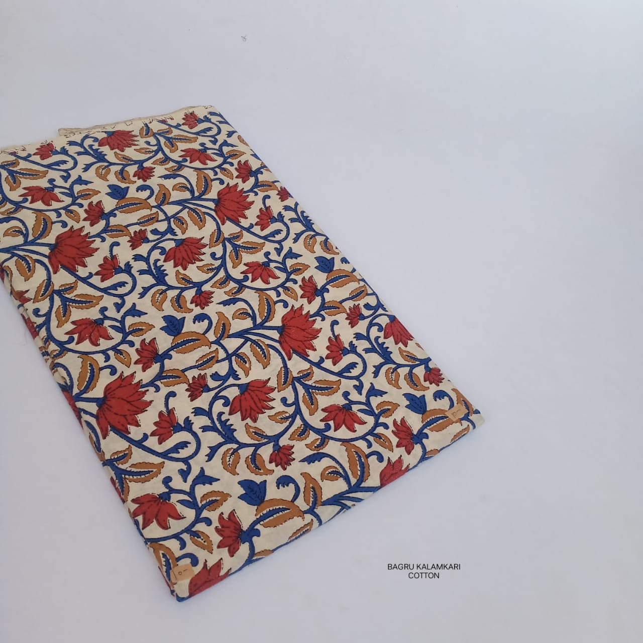 Handcrafted Bagru lotus floral jaal print on pure cotton fabric, artisan dyed and available wholesale through Fabtexs sustainable range.