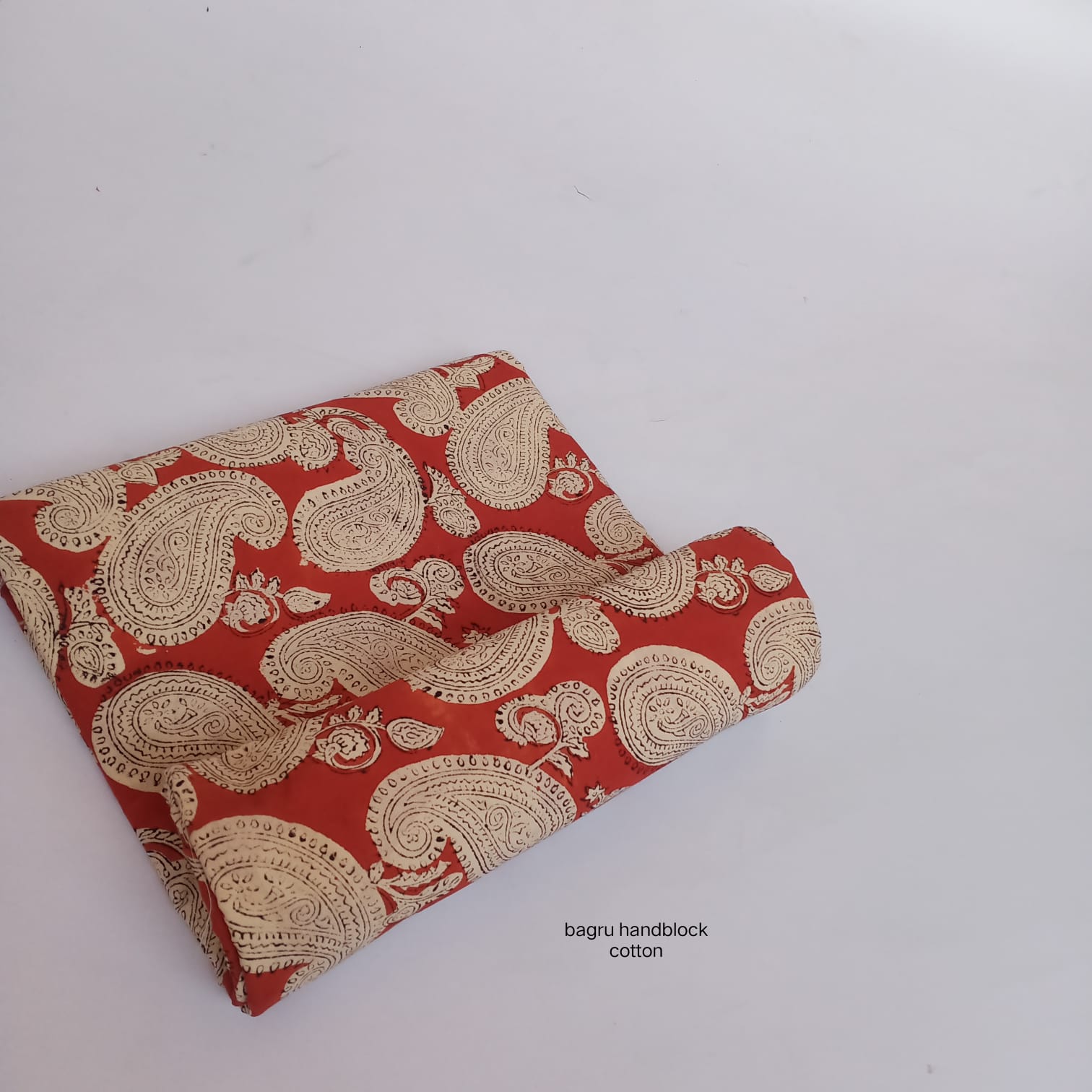 Madder red Bagru handblock cotton fabric featuring large paisley design, handcrafted wholesale fabric from Fabtexs