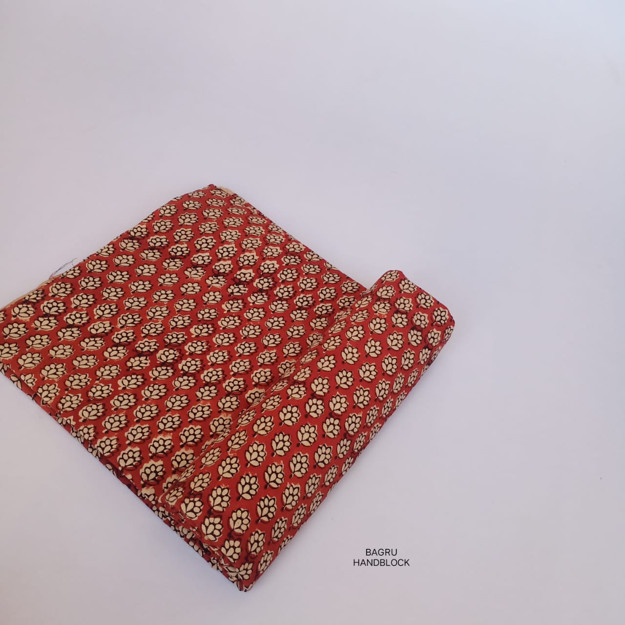 Floral rust Bagru handblock printed pure cotton fabric, ethically made with natural dyes for sustainable wholesale use.