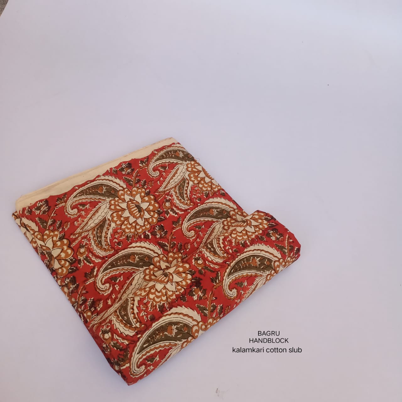 Rust-colored paisley Bagru handblock print on pure cotton fabric, artisan-made and perfect for ethnic fashion brands.