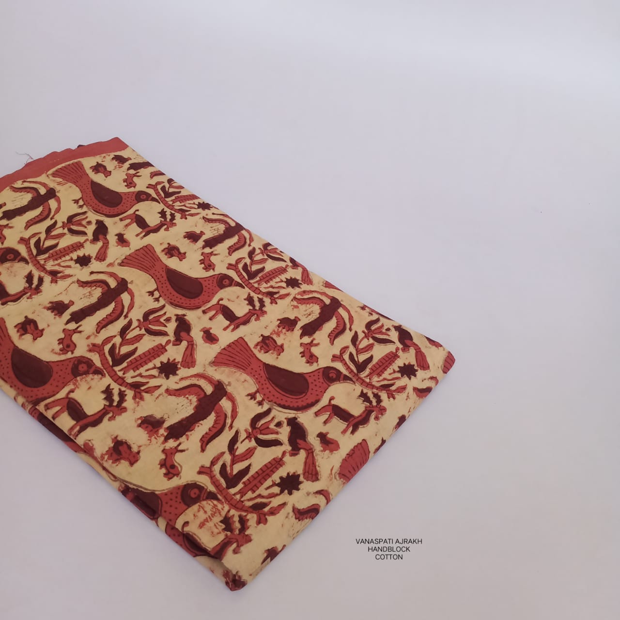 Cream Bagru handblock printed pure cotton fabric with Vanaspati bird design, naturally dyed and slow-made by artisans for Fabtexs.