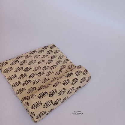 Soft cream floral Bagru handblock printed fabric, pure cotton, artisan-made and naturally dyed for sustainable designs.