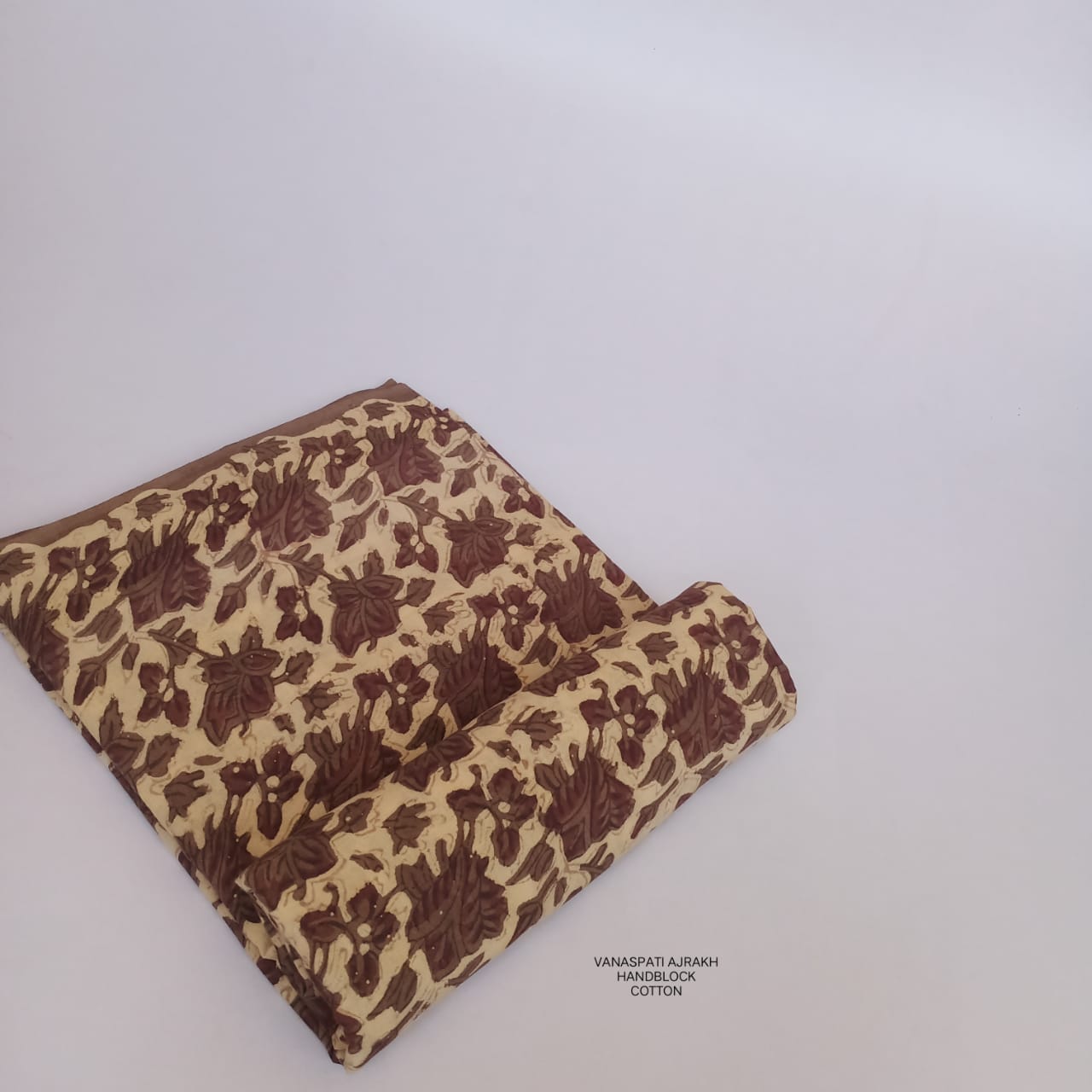 Cream Vanaspati Bagru handblock printed pure cotton fabric featuring floral motifs, natural-dyed and artisan printed for Fabtexs.