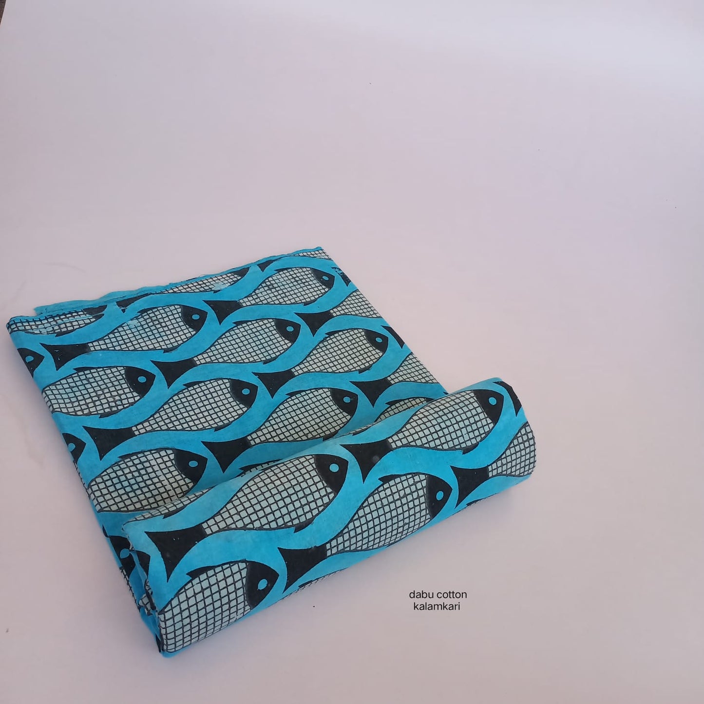 Blue fish Dabu handblock printed pure cotton fabric for bulk orders and boutique requirements.