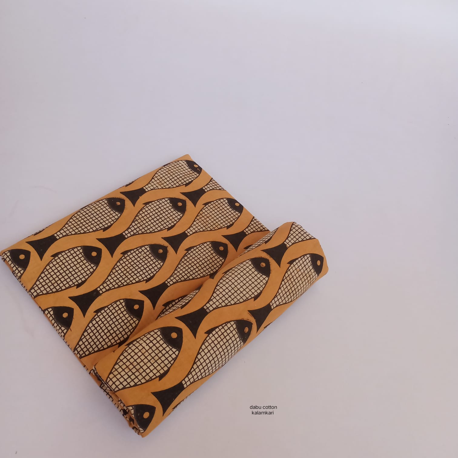 Mustard yellow fish-print Dabu cotton fabric, naturally dyed and crafted for wholesale sourcing.