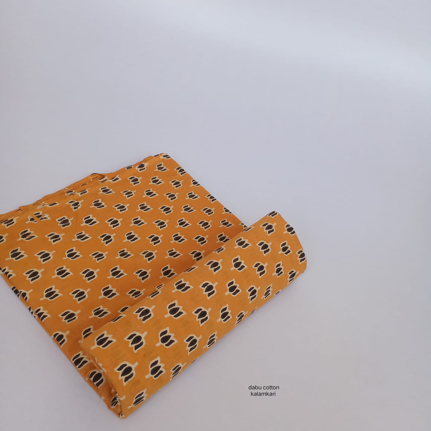 Mustard yellow lotus Dabu handblock cotton textile, naturally dyed and suitable for bulk buyers.