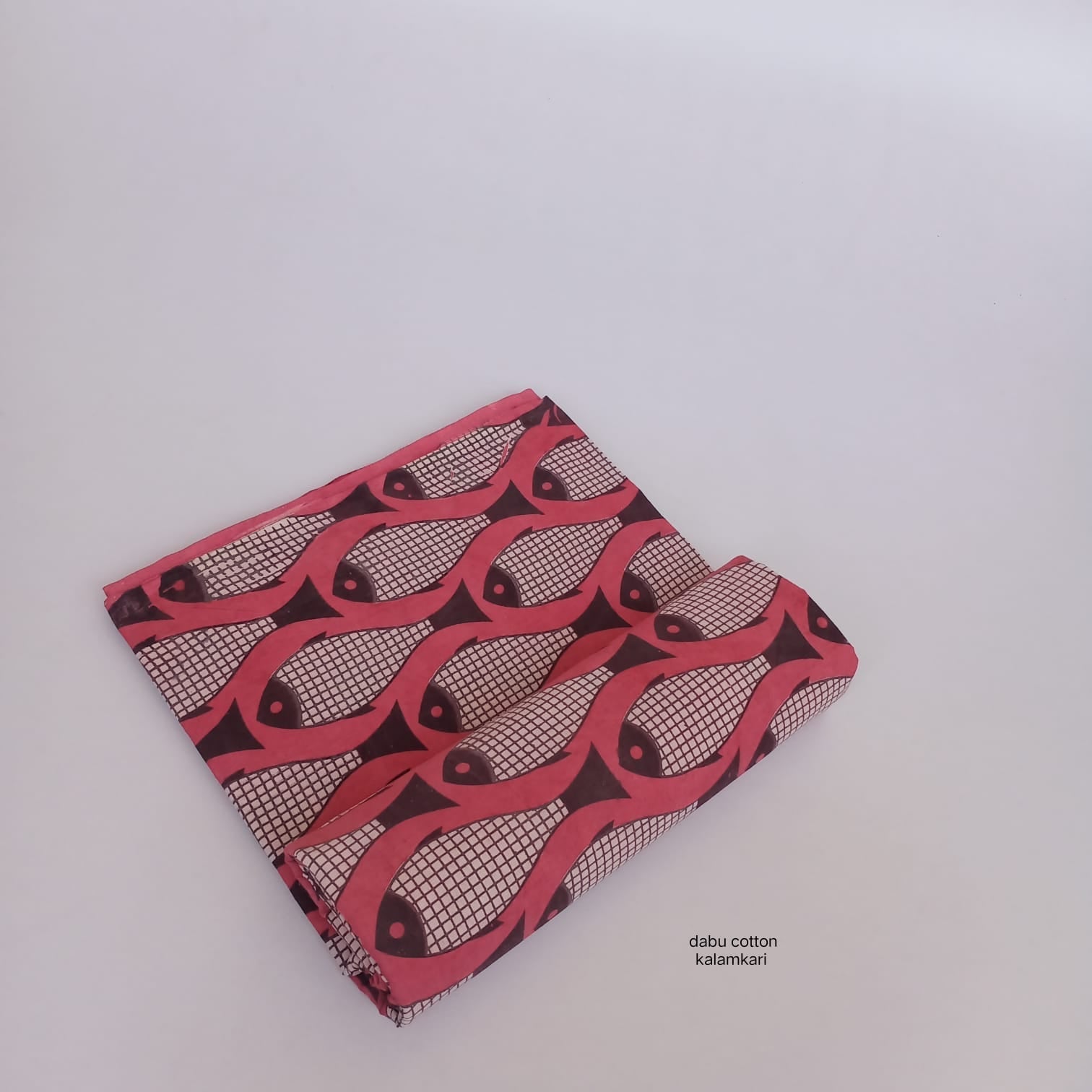 Red fish-design Dabu printed cotton fabric, handcrafted for bulk purchase and designer needs.