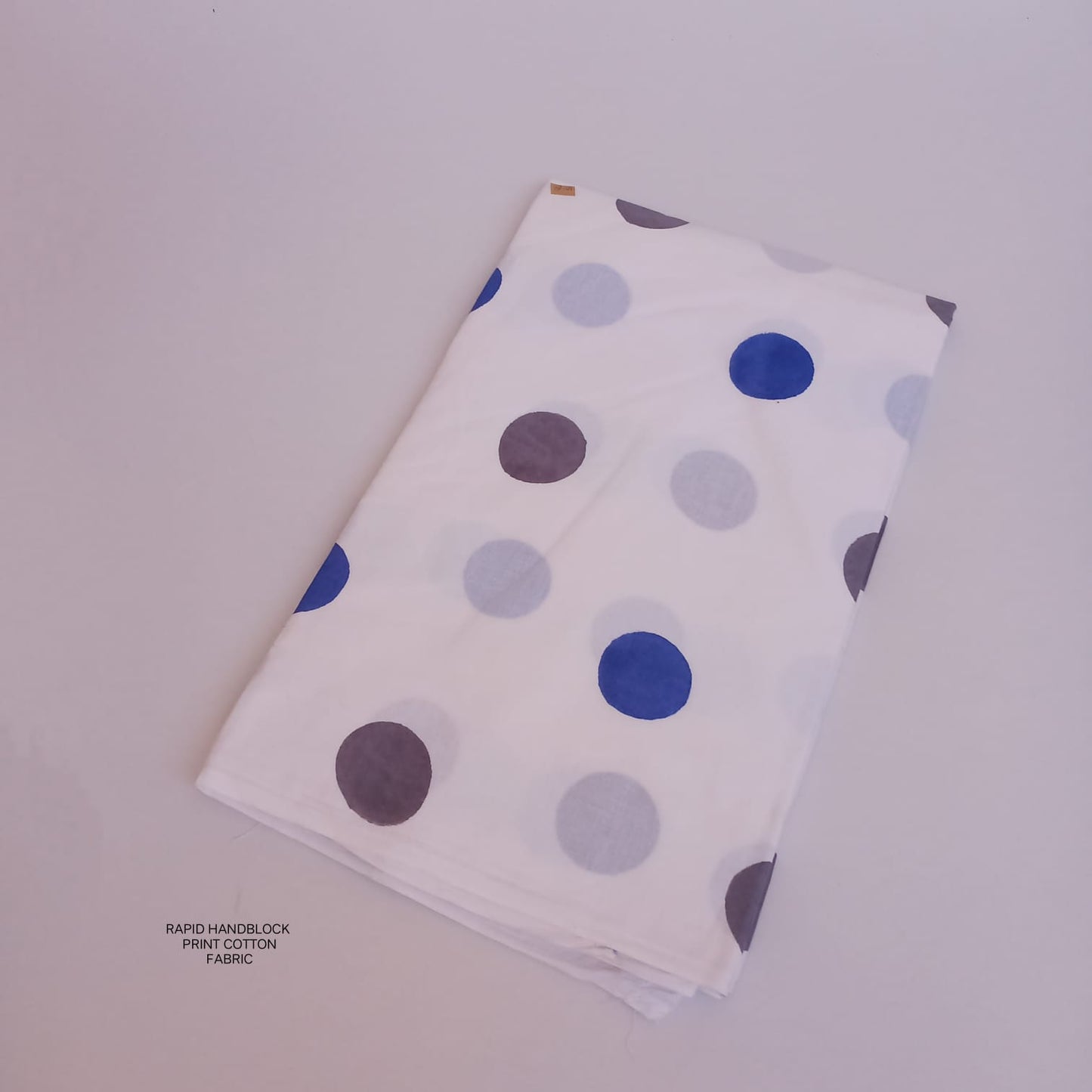 Jaipur Sanganeri handblock printed cotton fabric wholesale in white polka dot pattern