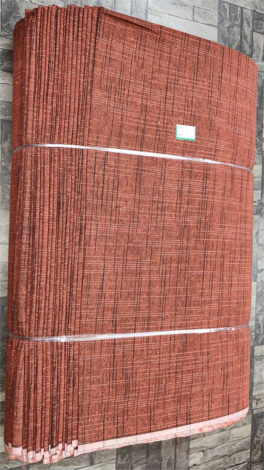 Black and rust slub khadi cotton textile, machine-woven for bulk garment and fabric supply