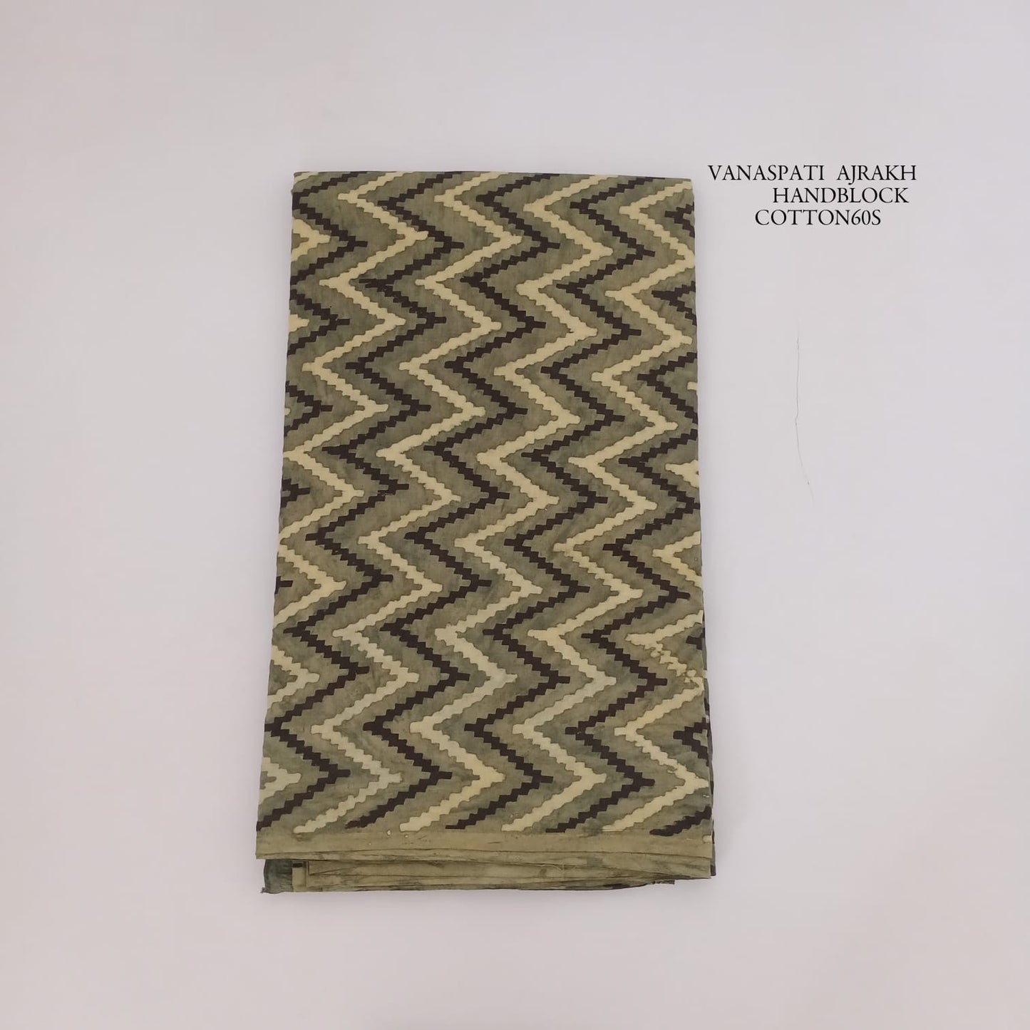 Olive zig-zag Vanaspati Bagru handblock printed pure cotton fabric, handcrafted using traditional wooden blocks for Fabtexs wholesale.